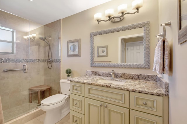 bathroom with tile patterned floors, vanity, toilet, and walk in shower