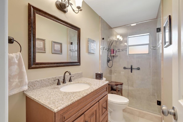 bathroom featuring tile patterned flooring, vanity, toilet, and a shower with shower door