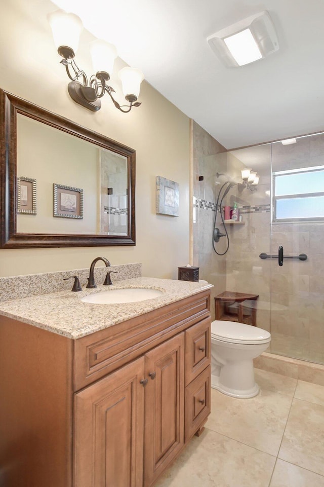 bathroom with tile patterned floors, a chandelier, an enclosed shower, toilet, and vanity