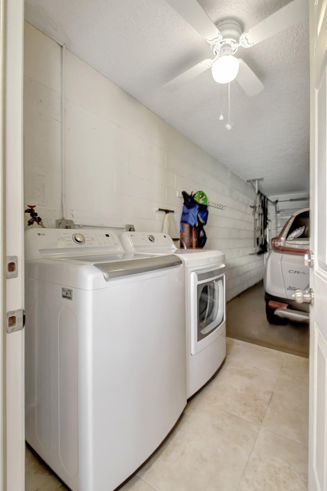 laundry room with washing machine and clothes dryer, ceiling fan, and a textured ceiling