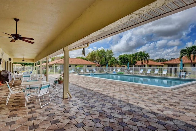 view of pool featuring ceiling fan, a patio area, and grilling area