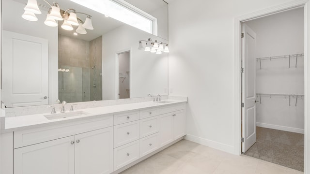 bathroom with tile patterned flooring, vanity, and an enclosed shower