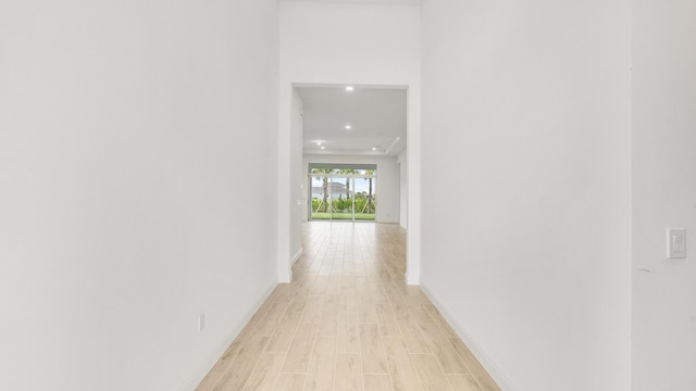 hallway with light hardwood / wood-style floors