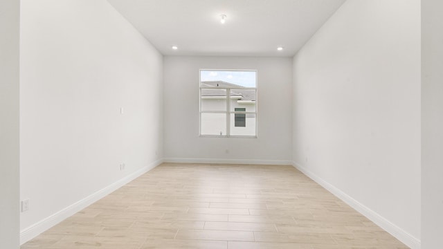 spare room with light hardwood / wood-style flooring