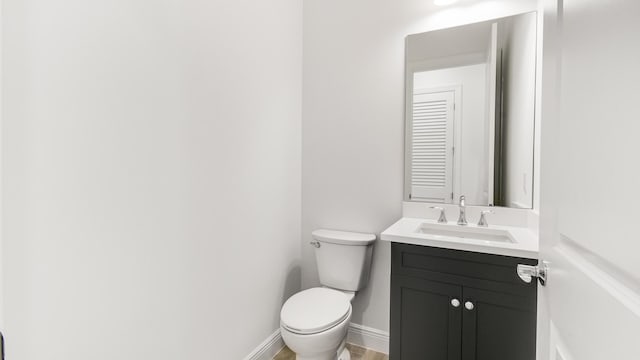 bathroom featuring vanity, toilet, and wood-type flooring