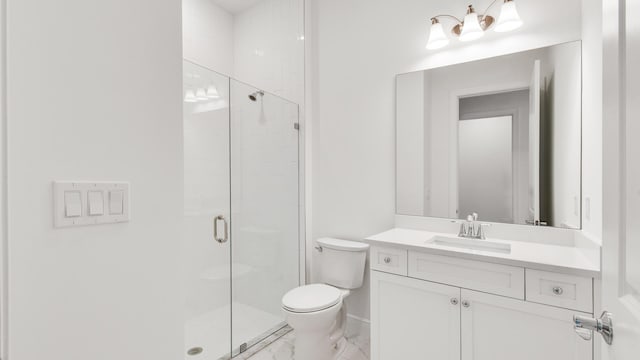 bathroom with vanity, a shower with shower door, and toilet