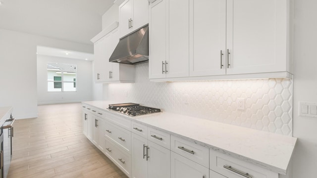 kitchen with light hardwood / wood-style floors, white cabinetry, and stainless steel gas stovetop