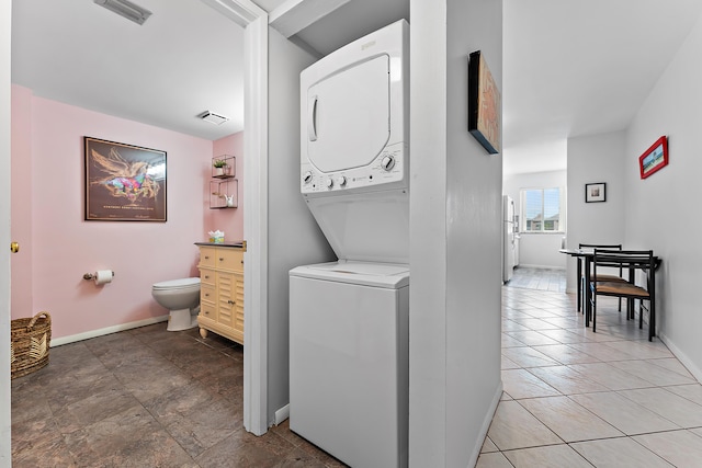 laundry room featuring stacked washer and dryer