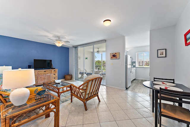 tiled living room with ceiling fan