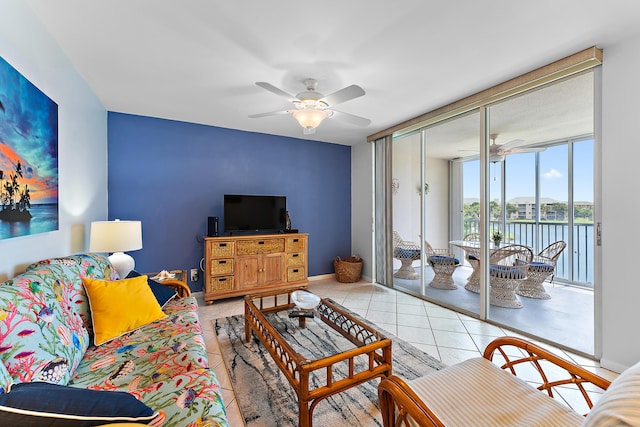 tiled living room with ceiling fan and expansive windows