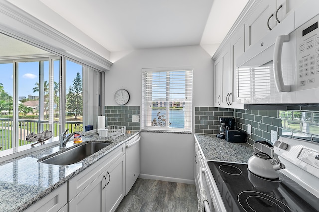 kitchen featuring white appliances, tasteful backsplash, white cabinetry, and sink