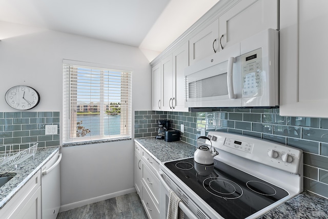 kitchen featuring decorative backsplash, light stone countertops, white appliances, wood-type flooring, and white cabinets