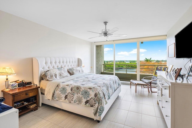 bedroom with expansive windows, access to exterior, and ceiling fan