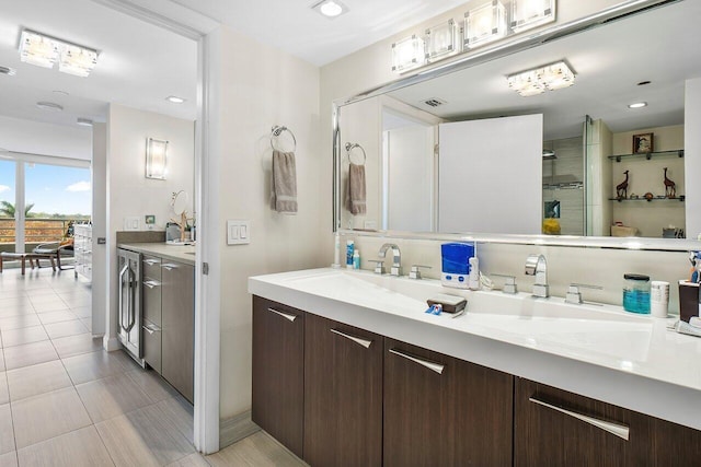 bathroom with vanity, tile patterned floors, washer and clothes dryer, and walk in shower