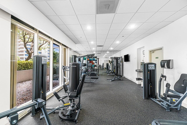 gym with a paneled ceiling