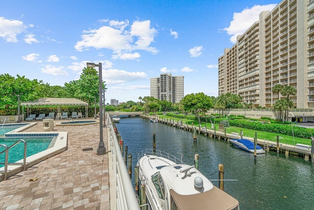 exterior space with a water view, a boat dock, and a patio area