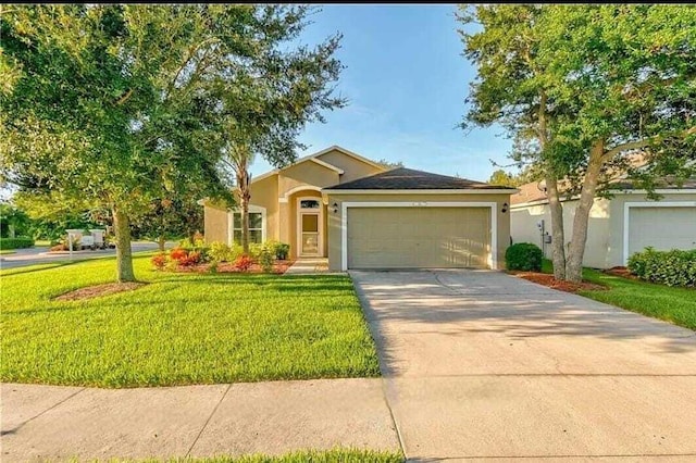 ranch-style home with a front yard and a garage