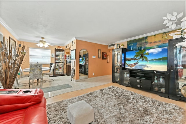 tiled living room featuring ceiling fan and crown molding