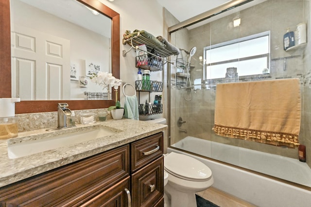 full bathroom with vanity, toilet, and bath / shower combo with glass door