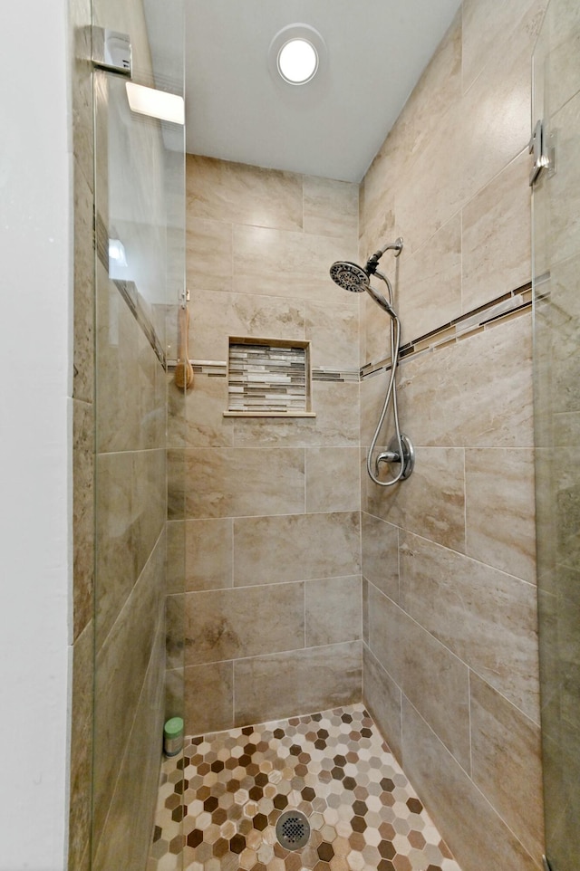 bathroom with tiled shower