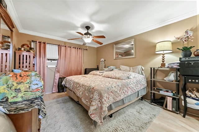 bedroom featuring ceiling fan, light wood-type flooring, and ornamental molding