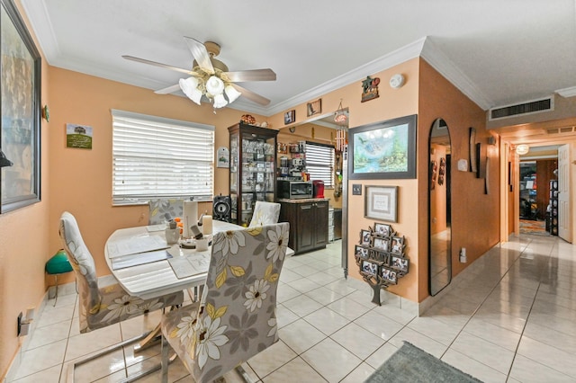 dining area featuring light tile patterned floors, ceiling fan, and crown molding