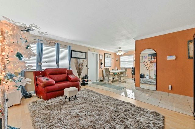 living room with ceiling fan, light hardwood / wood-style flooring, and crown molding