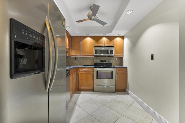 kitchen featuring backsplash, stainless steel appliances, ceiling fan, and light tile patterned flooring