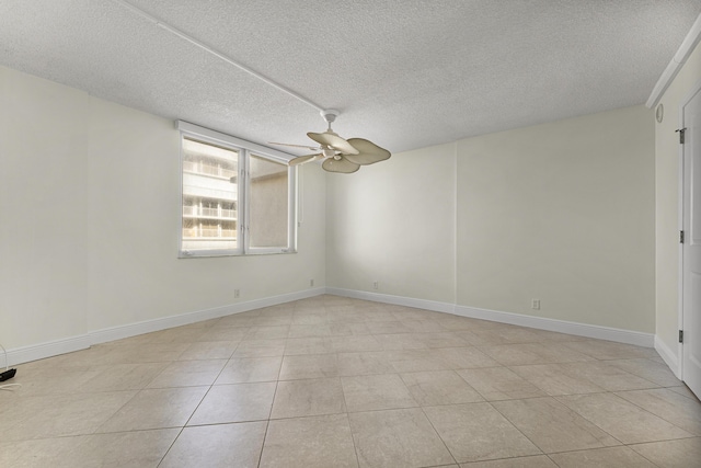 tiled spare room with ceiling fan and a textured ceiling