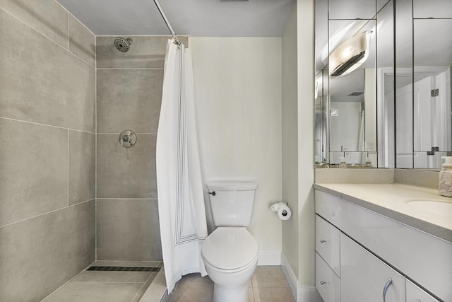 bathroom featuring tile patterned flooring, a shower with curtain, vanity, and toilet