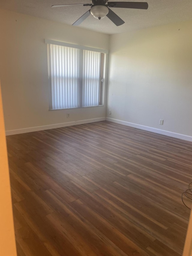 spare room featuring a textured ceiling, ceiling fan, and dark hardwood / wood-style floors