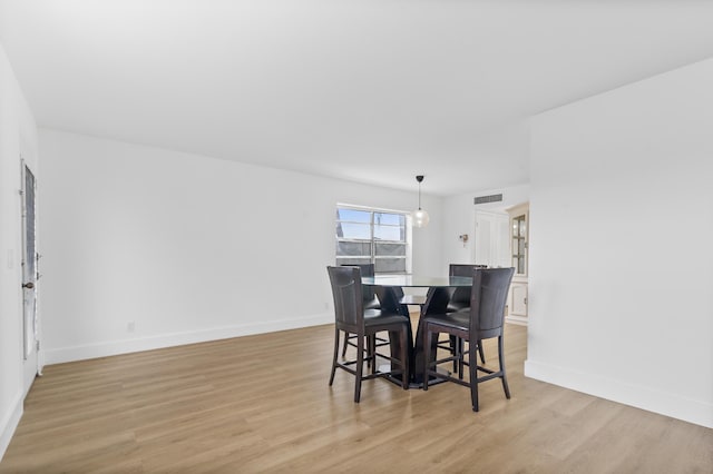 dining area with light hardwood / wood-style flooring