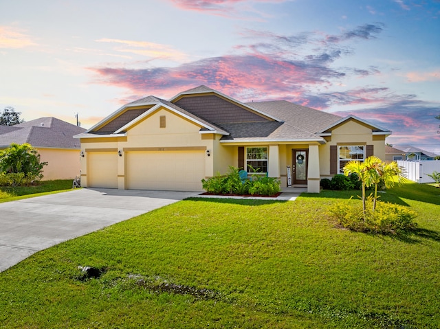 view of front of house featuring a garage and a yard