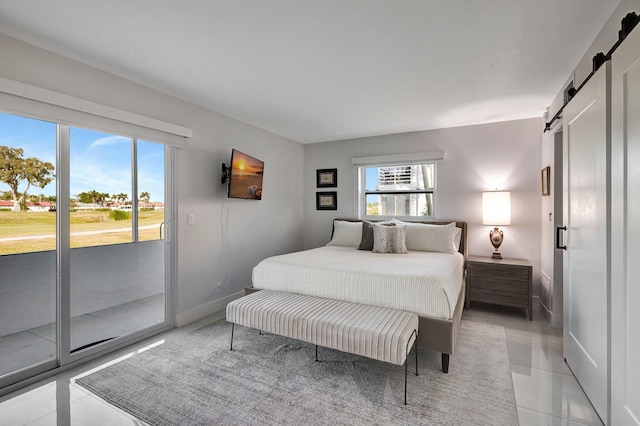 tiled bedroom featuring a barn door and access to outside