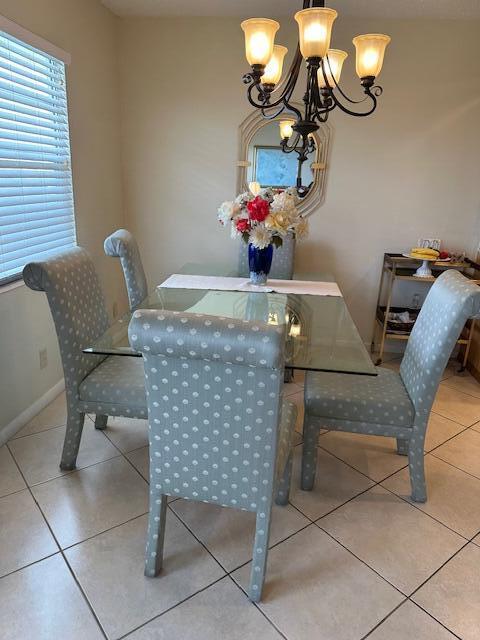 dining area featuring light tile patterned floors and a chandelier