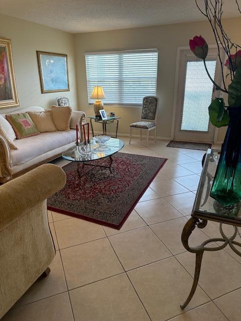 living room with light tile patterned floors and a textured ceiling