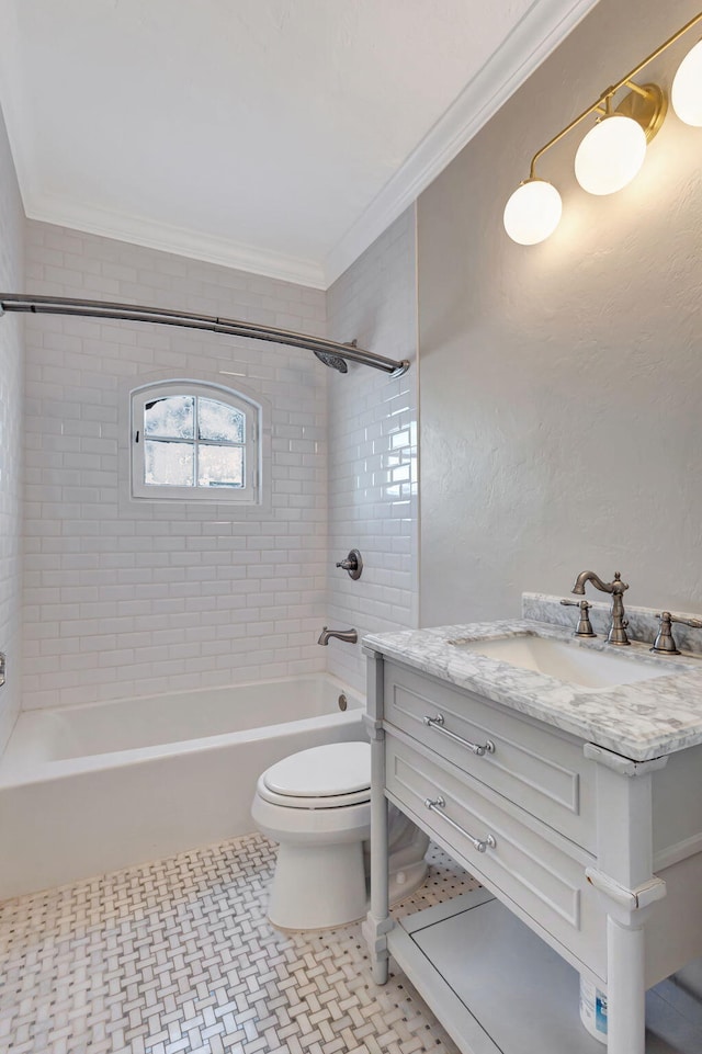 full bathroom featuring tile patterned floors, vanity, tiled shower / bath combo, crown molding, and toilet