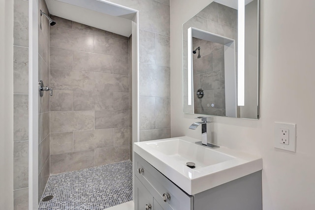 bathroom with vanity and tiled shower