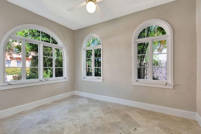 empty room with plenty of natural light and ceiling fan