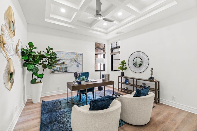 office space featuring a ceiling fan, coffered ceiling, light wood-style flooring, and baseboards