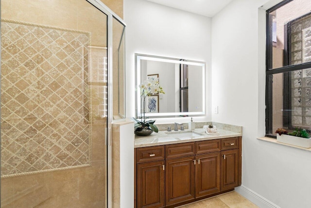 full bathroom with baseboards, a stall shower, vanity, and tile patterned floors