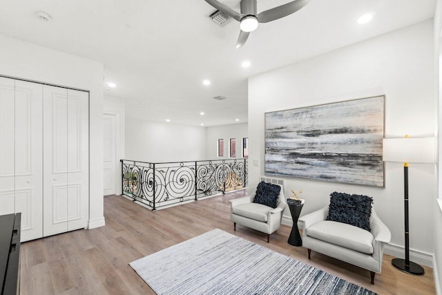 living area with visible vents, ceiling fan, an upstairs landing, light wood-style floors, and recessed lighting