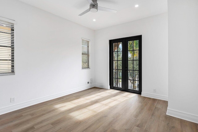 unfurnished room with french doors, recessed lighting, ceiling fan, light wood-type flooring, and baseboards