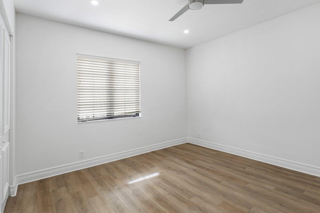 spare room with ceiling fan, recessed lighting, wood finished floors, and baseboards