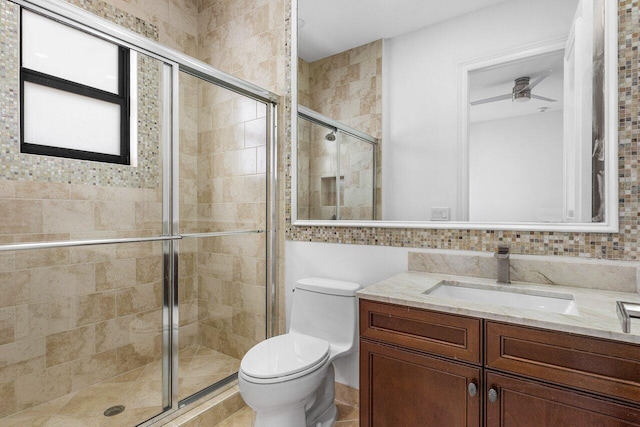 bathroom featuring vanity, a shower stall, and toilet