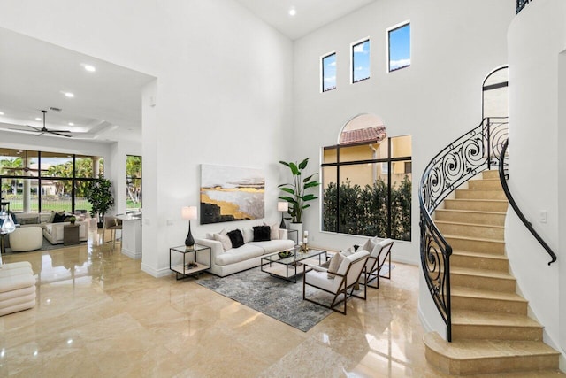 living room featuring marble finish floor, stairway, a tray ceiling, and recessed lighting