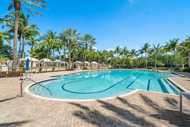 pool featuring a patio area and fence