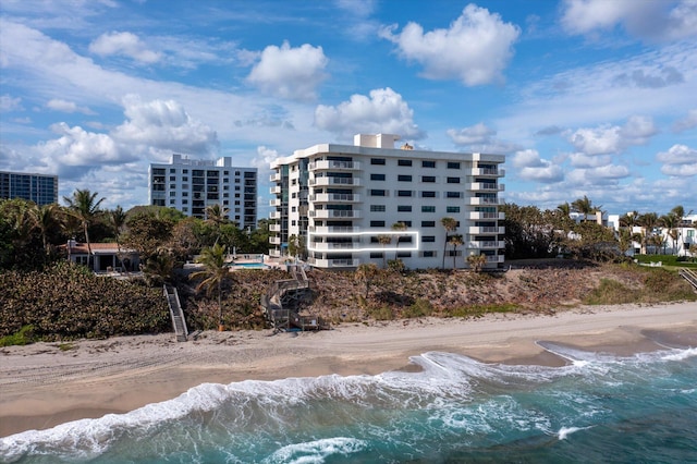 view of property with a beach view and a water view