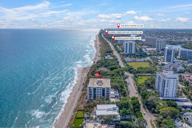 birds eye view of property with a water view and a view of the beach