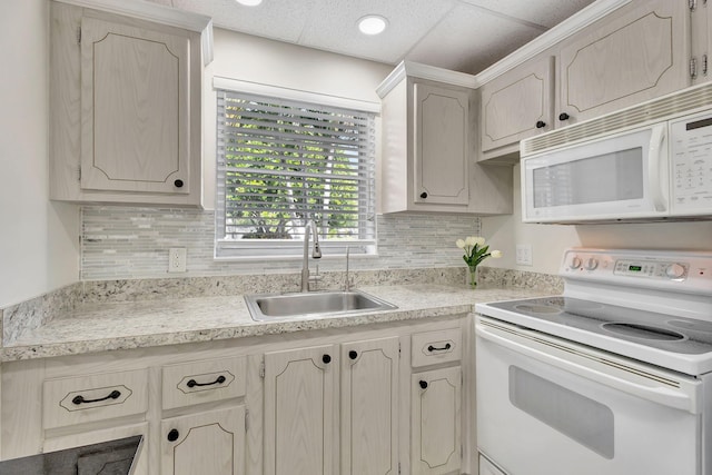 kitchen featuring a paneled ceiling, backsplash, white appliances, and sink